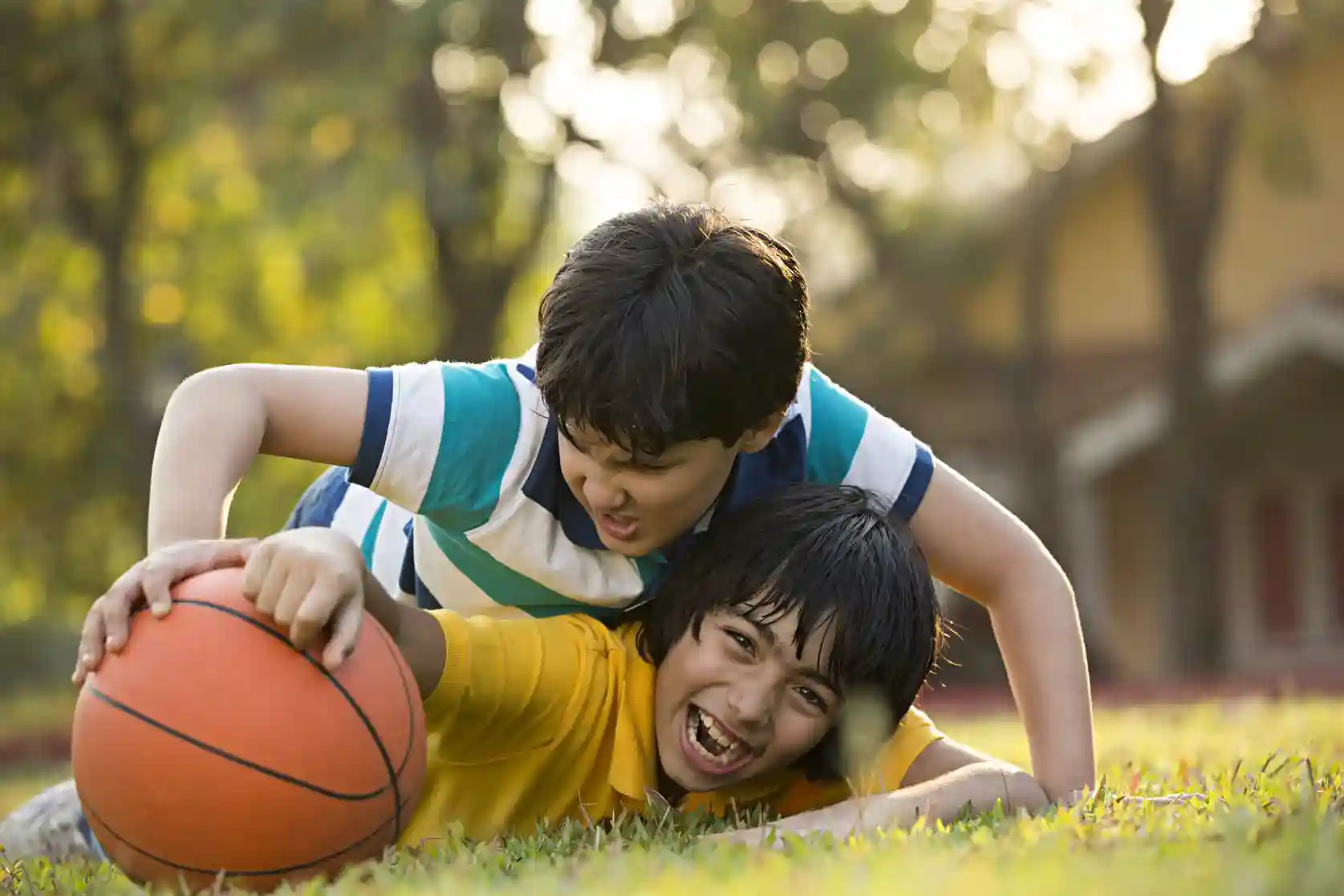 Two children playing with a basketball